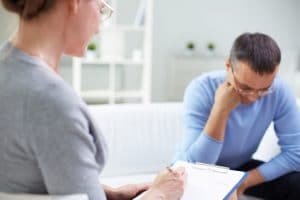 Female psychologist treating male patient for PTSD