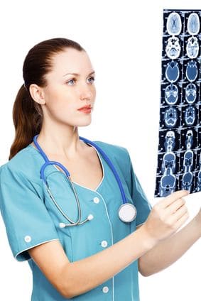 Female doctor reviews brain MRI