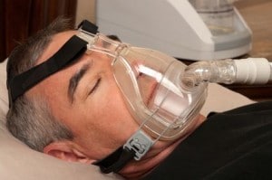 Patient laying down wearing an oxygen mask