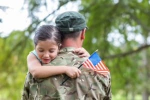 Child hugging Army veteran