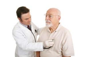 Doctor holding stethoscope to patient's chest